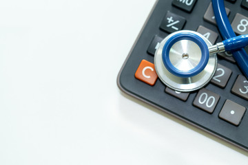 Obraz premium Close up of stethoscope on calculator.