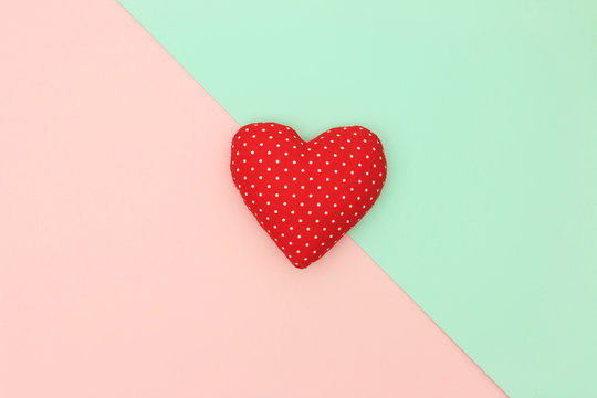 Red heart with copy space on pastel background. Love and Valentine day concept. Minimal style.