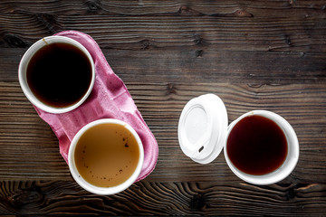 Coffee take away. Coffee cups with covers on wooden table backound top view copyspace
