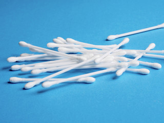 Cotton buds on blue background