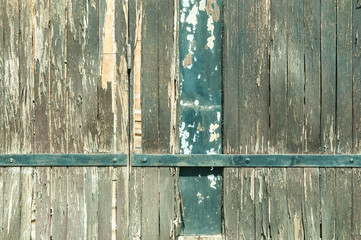 Aged wooden fence texture with metal plate background.