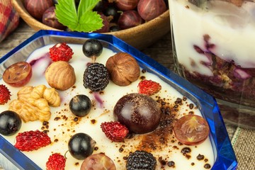 Vanilla pudding with summer fruit on a wooden table. Healthy snacking for kids.