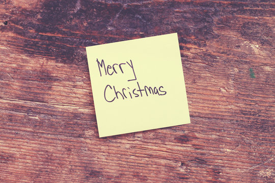 Retro old style ohoto of message Merry Christmas on wooden table