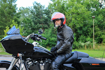 Man in a red helmet on the black motorcycle