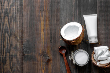 Skin care. Coconut oil and cream on wooden table background top view copyspace