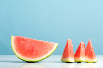 Sliced watermelon on a light blue background