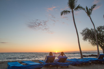Couple enjoys Hawaiian sunset on beach