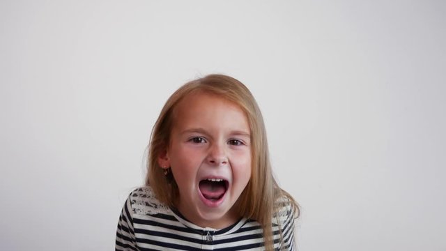 Closeup girl screaming into the camera