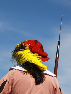 backside of a man in a middle age costume