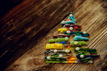 Christmas tree decorated with glass and wooden vintage toys in pastel colors