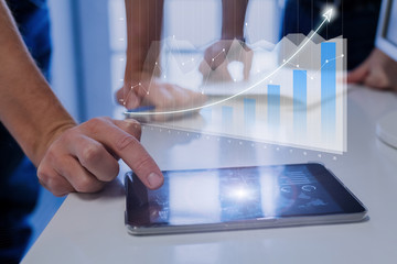AR financial charts showing growing revenue, digital tablet screen, businessmen