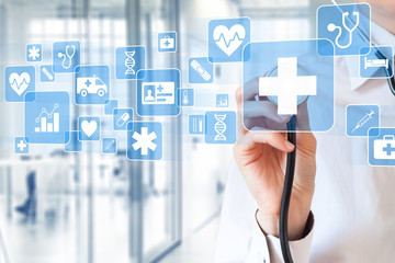 Medical doctor holding stethoscope touching healthcare icons, hospital interior background