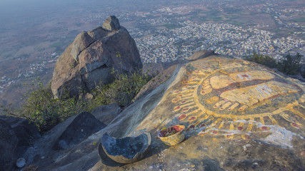 A stone with the image of the footprints of a guru on top of a mountain Arunachala. © kalcutta