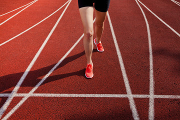 Athlete on starting line waiting for the start in running track 