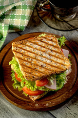 Sandwich with ham, cucumber, tomato and lettuce.