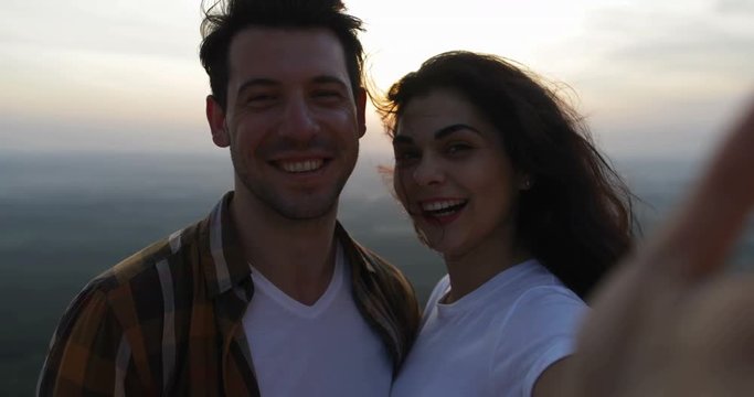 Couple On Mountain Top Taking Selfie Photo At Sunrise, Tourists Man And Woman Happy Smiling Slow Motion 60