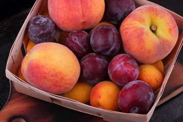 Peaches, apricots and plums in the basket