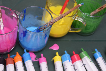 Glasses with colored paints and syringes for spraying