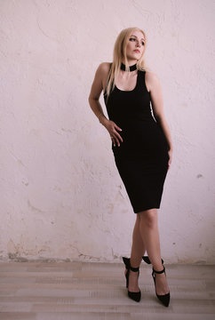 Elegant fashionable sensual blonde middle aged woman in black dress