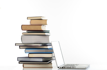 Books stack and a laptop on white background