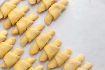 Process of cooking small croissants with cerry for breakfast. Preparation of baking on a rustic white background.