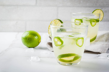 Mexican traditional refreshing drink Fresh Lime and Jalapeno Margarita with tequila, hot pepper and...