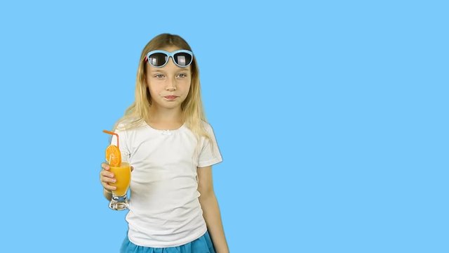 Young girl in white t-shirts drinking orange juice from glass and show thumbs up. Happy girl drink orange cocktail through straw. Clip with Premultiplied matted Alpha Channel. Transparent BG PNG.