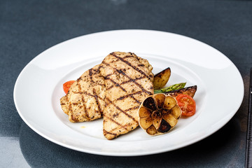 Grilled chicken fillet with french fries and asparagus