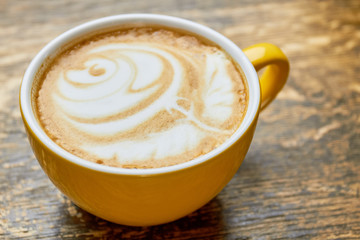 Latte cup with foam art. Coffee close up.