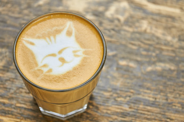 Cat coffee art. Latte glass with foam.