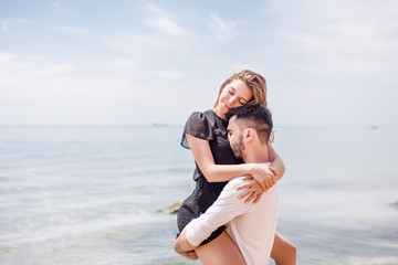 Beautiful Couple At Beach.Outdoor portrait happy beautiful couple,couple having fun by sea,enjoy vacation,trendy hipster look,happiness,love,summer holidays,man touching girlfriend,tan