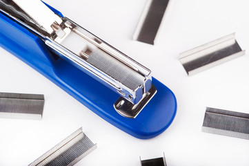 Blue Stapler with staples wires on white background.