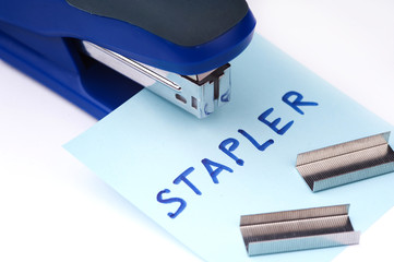 Blue Stapler with staples wires on white background.