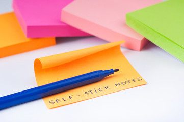 self-stick notes lie wite background