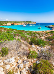 Fototapeta na wymiar Beautiful seaside scenery on Majorca island, stunning bay with boats at Cala Varques, Spain Mediterranean Sea, Balearic Islands