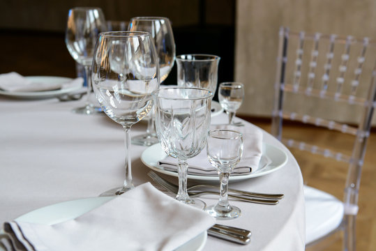 Serving a formal dining event, glasses and dishes for consumers. Cutlery for people in the restaurant.
