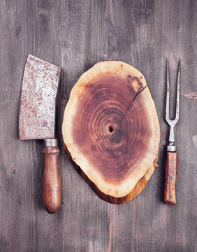 Wooden cut with cleaver knife and fork. Food concept background