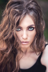 Naklejka premium Face of beautiful brunette close-up. Beautiful, young brunette. Toneed image.