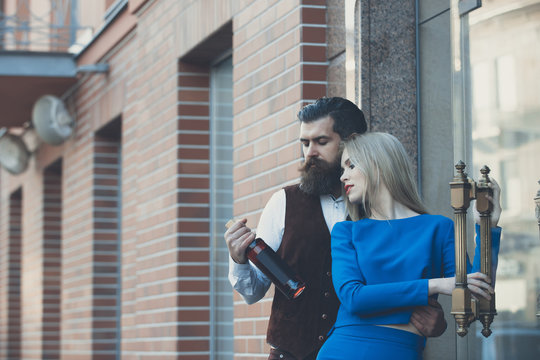 Girlfriend and boyfriend looking at bottle of wine