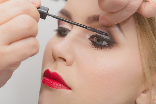fashion model girl getting mascara on eyelashes