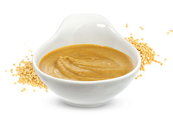 Mustard sauce and seeds isolated on white