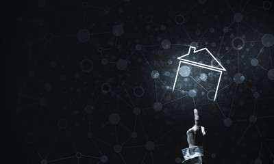 Conceptual image with hand pointing at house or main page icon o