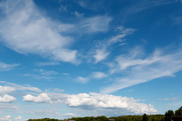 Fototapeta na wymiar White fluffy big clouds against blue sky