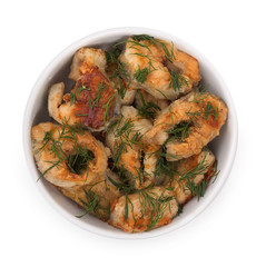 Pieces of fried fish, served on a dish with green dill isolated on a white background. Top view, close up.