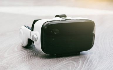 Virtual reality glasses on wood background