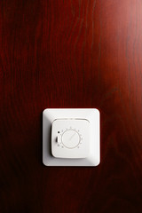 thermostatic climate control system, red wood mahogany background