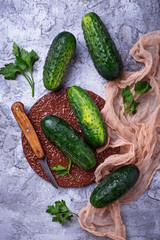 Fresh cucumbers on concrete background