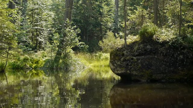 Slowly moving forward on a canoe trough calm waters.