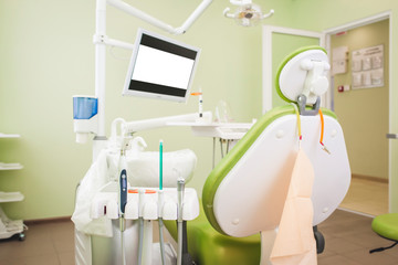 Dentistry, medicine, medical equipment and stomatology concept - interior of new modern dental clinic office with chair.