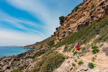 Naklejka premium Man running in inspirational mountains and seaside